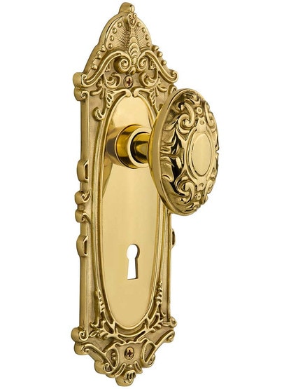 Largo Door Set with Decorative Oval Knobs and Keyhole in Un-Lacquered Brass.